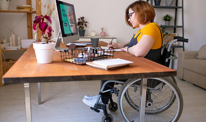 Woman working from home in wheelchair at table